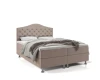 Beiges Boxspringbett mit gepolstertem Kopfteil und silbernen Füßen.