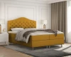 Senfgelbes Boxspringbett als Highlight in modern eingerichtetem Schlafzimmer.