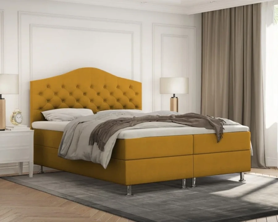 Senfgelbes Boxspringbett als Highlight in modern eingerichtetem Schlafzimmer.