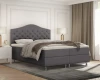 Graues Boxspringbett mit geschwungenem, gestepptem Kopfteil.