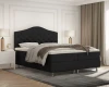 Schwarzes Boxspringbett mit hohem, gestepptem Kopfteil.