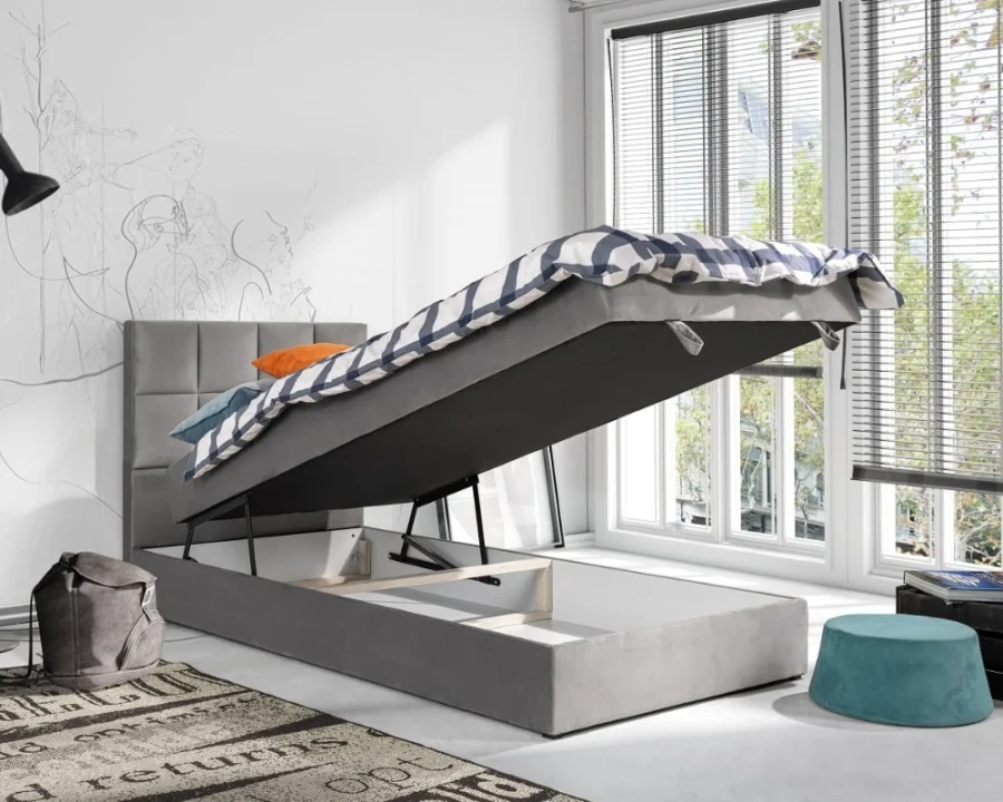 Graues Einzelbett mit praktischem Bettkasten für zusätzlichen Stauraum im Kinderzimmer.
