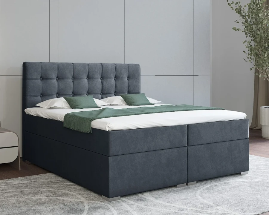 Boxspringbett in Dunkelblau mit stilvoller Knopfsteppung am Kopfteil.