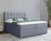 Hellblaues Boxspringbett mit dekorativ abgestepptem Kopfteil.