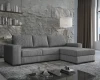 Graues Cord-Ecksofa mit Ottomane in stilvoller Wohnlandschaft.