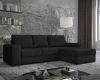 Dunkelgraues Cord-Ecksofa in modernem Wohnzimmer mit Steinwand-Optik.