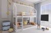 White bunk bed in house shape in the children's room with colourful decoration and toys.