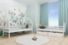 Modern children's room with a white house bed and decorative jungle wallpaper.