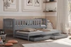 Grey children's functional bed with pull-out bed and two drawers in the children's room.