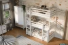 Triple-stapelbed in het wit met dekbedovertrek met bladmotief in een speelse kinderkamer