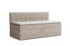 Beiges Polsterbett mit Bettkasten und dekorativer Knopfheftung, elegantes Tagesbett.