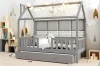 Graues Hausbett mit Lichterkette, Ausziehkasten und gepolstertem Rückenteil im gemütlichen Kinderzimmer.