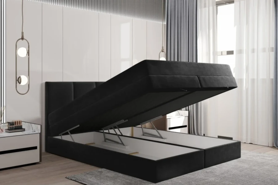 Schwarzes Funktionsbett mit weit geöffnetem Bettkasten für viel Stauraum im Schlafzimmer.