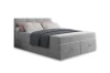 Modernes hellgraues Boxspringbett mit praktischem Bettkasten und gemütlichen Kissen.