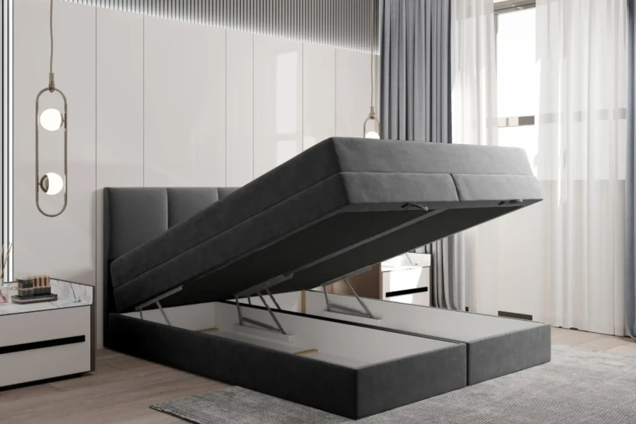 Dunkelgraues Boxspringbett mit offenem Stauraumfach unter der Matratze.