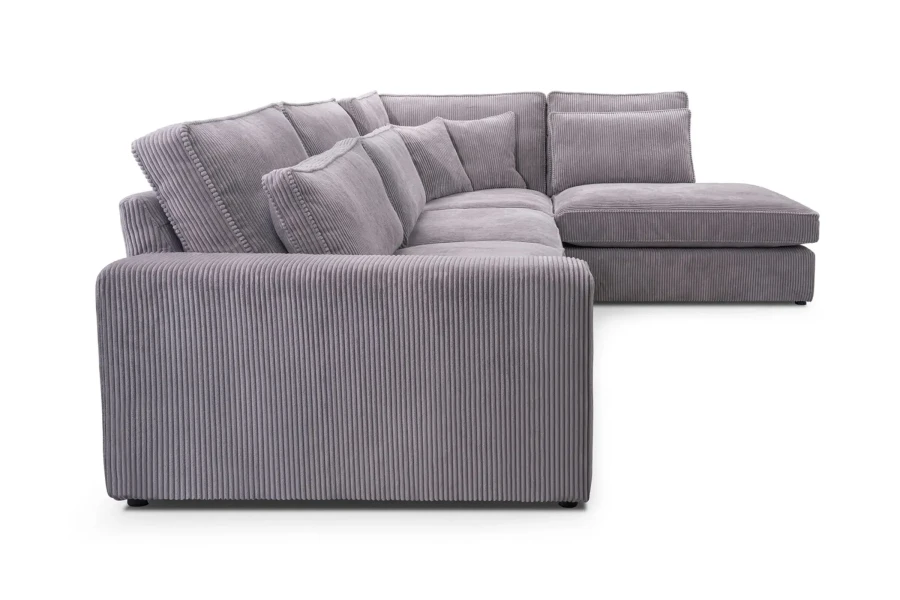 Lila Wohnlandschaft Caren XL aus Poso Cord, gemütliches Ecksofa mit Kissen.