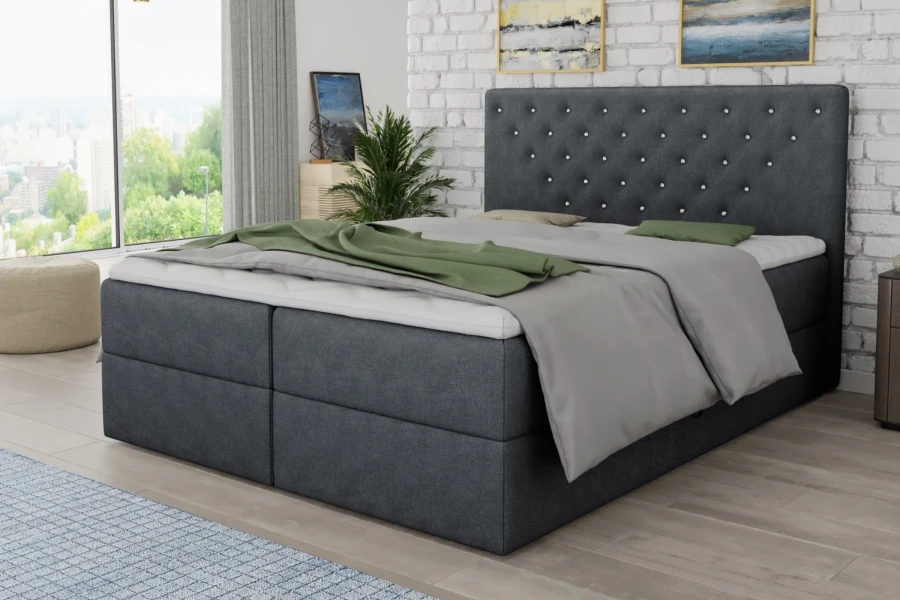 Modernes Schlafzimmer-Ambiente mit einem dunkelgrauen Boxspringbett und stilvoller Deko.