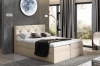 Beiges Boxspringbett mit gestepptem Kopfteil und weißer Matratze.