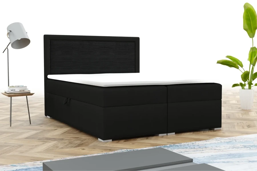 Zwart boxspringbed met opvallend hoofdbord in een stijlvolle slaapkameromgeving.