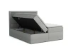 Grijs boxspringbed met geopende bedbak voor praktische opbergruimte.