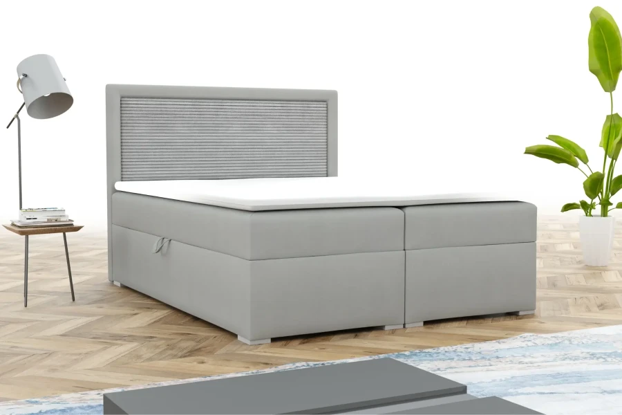 Modern grijs boxspringbed met gestoffeerd hoofdbord in een lichte slaapkameromgeving.