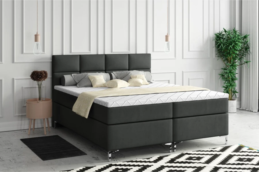 Modern donkergrijs boxspringbed met gestoffeerd hoofdbord in een stijlvolle slaapkamerambiance.
