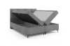 Functioneel boxspringbed met twee zijwaarts openslaande bedbakken in het grijs.