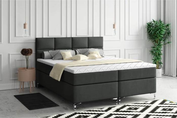 Modern zwart boxspringbed in een gezellige slaapkamerambiance