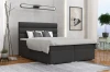 Modern ingerichte slaapkamer met stijlvol boxspringbed in antraciet.
