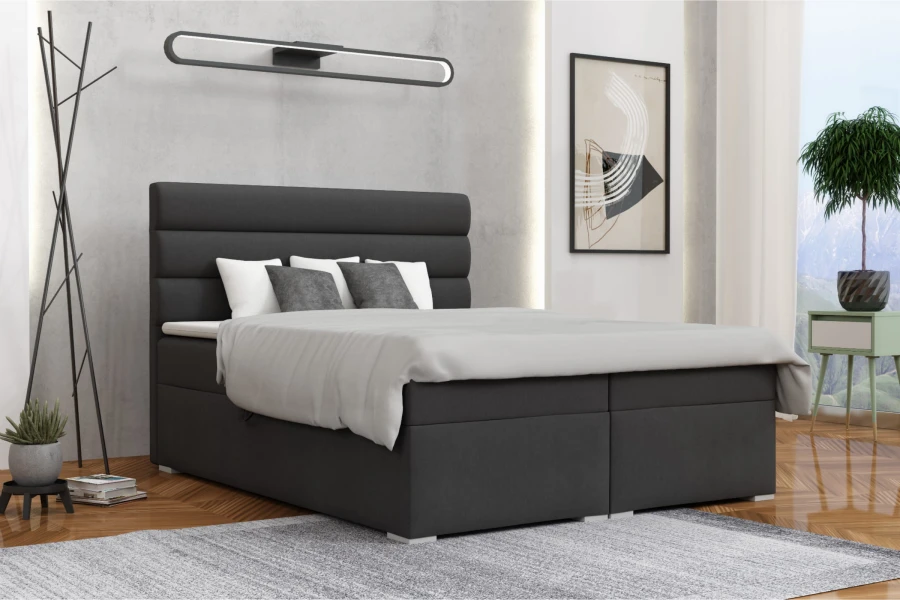 Modern ingerichte slaapkamer met stijlvol boxspringbed in antraciet.