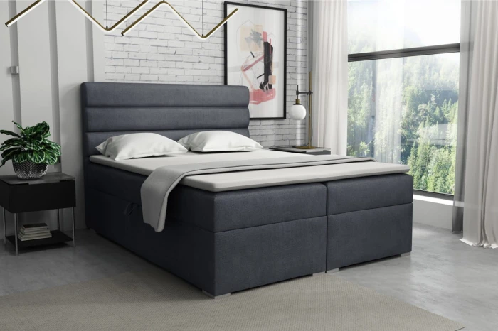 Donkergrijs boxspringbed in een modern ingerichte slaapkamer met raampartij.
