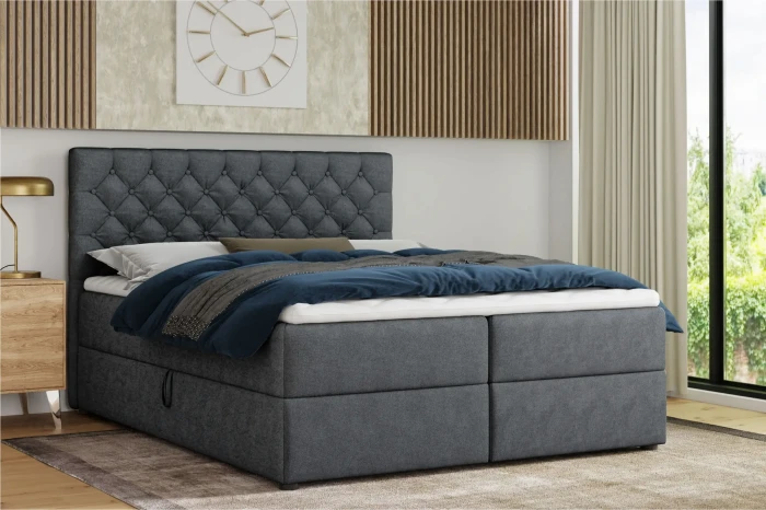 Antracietkleurig boxspringbed met gecapitonneerd hoofdbord in een modern slaapkamerinterieur