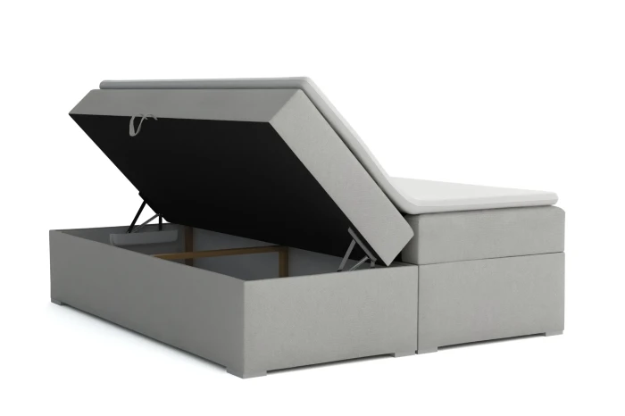Functioneel boxspringbed in lichtgrijs met geopende opbergruimte voor extra opbergruimte