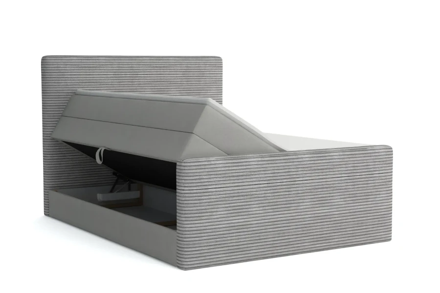 Boxspring in cord grijs met opbergfunctie en gestoffeerd hoofdbord in zijaanzicht.