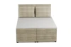 Frontal view of a beige box-spring bed with corduroy upholstery and two large back cushions.