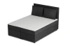 Zwart corduroy boxspringbed met hoofdbord in perspectivisch aanzicht.