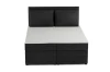 Vooraanzicht van een zwart boxspringbed met corduroy bekleding en twee kussens.