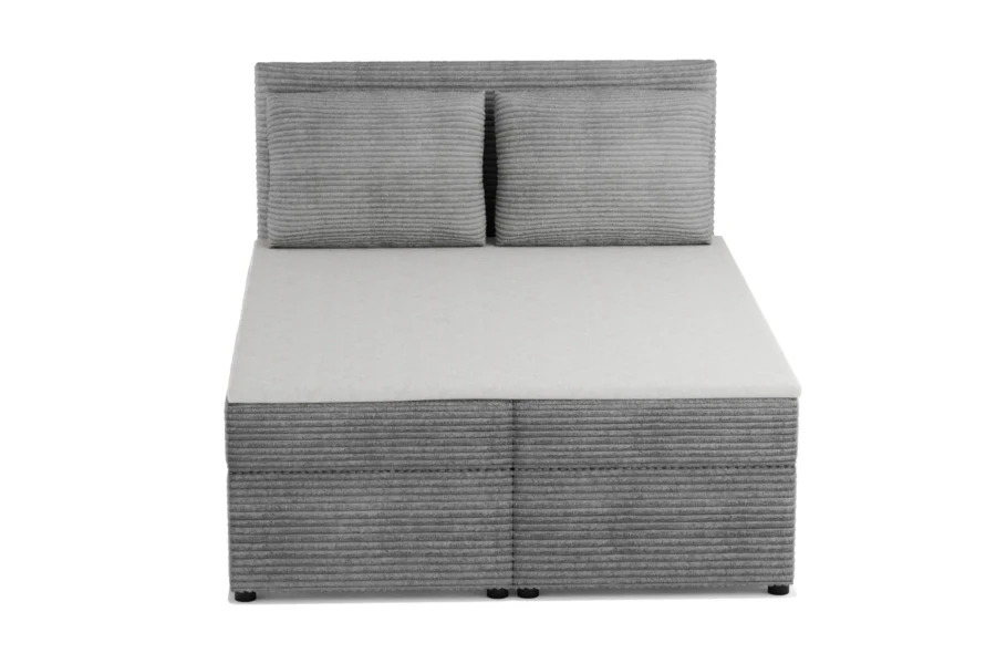Front view of the grey boxspring bed with corduroy cover and matching headboard.