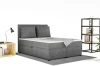 Grijs boxspringbed TAMI met ribstof bekleding in een moderne slaapkamerambiance.