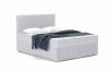 Silbergraues Boxspringbett mit Bouclé-Bezug und dunkelblauer Decke.