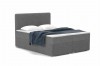 Dunkelgraues Boxspringbett aus Bouclé mit Kissen und blauer Decke.