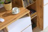 Eichenholz-Schreibtisch mit Tasse und angrenzendem Bücherregal.