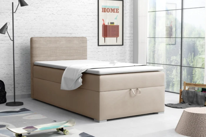A beige single bed in a modernly designed teenager's room with a white brick wall.