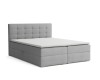 Hellgraues Boxspringbett mit quadratisch gestepptem Kopfteil.