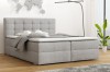 Modernes Boxspringbett in Grau im wohnlichen Schlafzimmer-Ambiente.