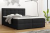 Elegantes schwarzes Boxspringbett mit gestepptem Kopfteil im Schlafzimmer.