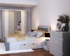 Funktionsbett mit Bettkasten, passende Kommode und Schiebetürenschrank im modernen Schlafzimmer-Design.