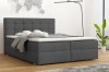 Graues Boxspringbett in modern eingerichtetem Schlafzimmer mit Holzboden.