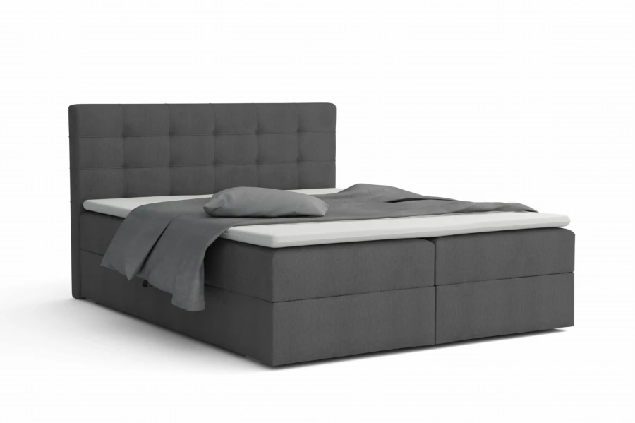 Graues Boxspringbett mit gestepptem Kopfteil und Matratze auf weißem Hintergrund.