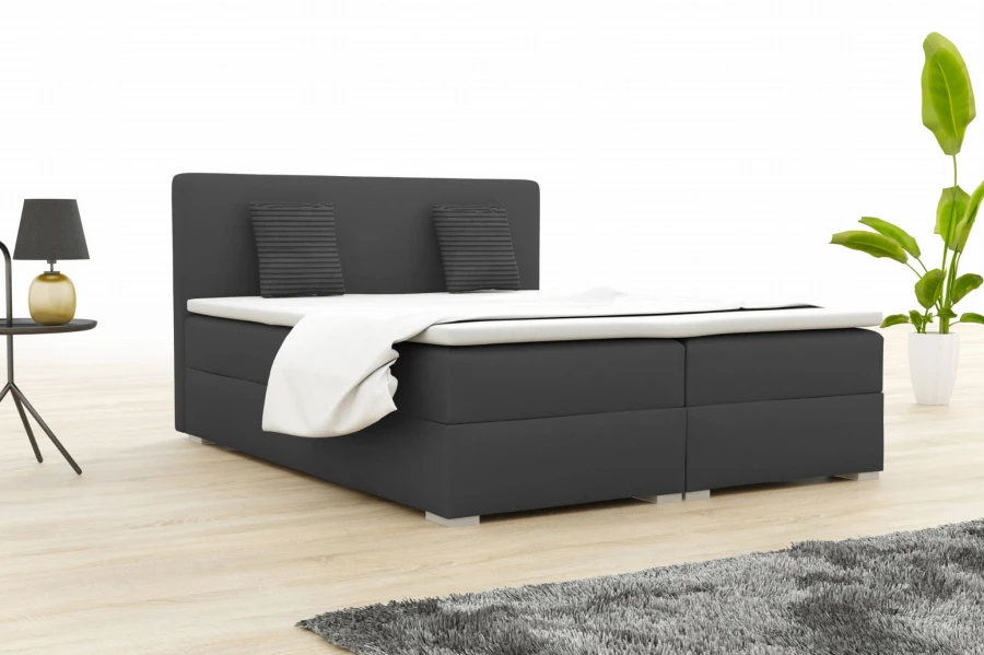 Anthrazitfarbenes Boxspringbett für zeitloses Schlafzimmer-Design.
